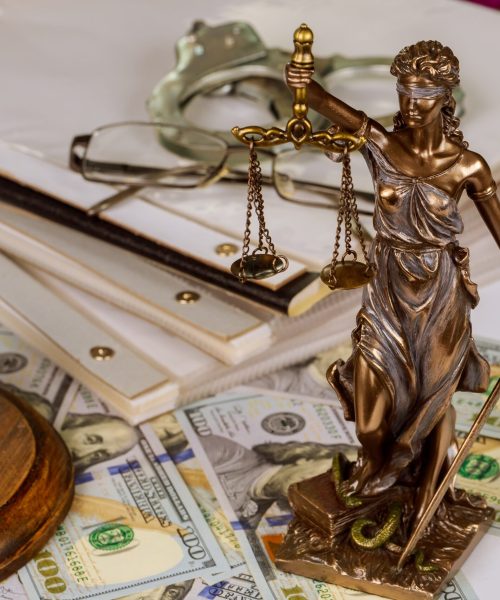 Legislation office statue of justice symbol on workplace law document with Judge's gavel police handcuffs